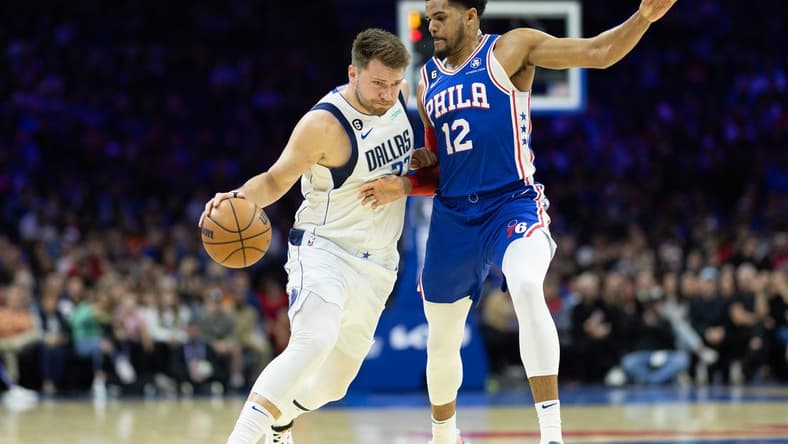Mar 29, 2023; Philadelphia, Pennsylvania, USA; Dallas Mavericks guard Luka Doncic (77) dribbles the ball against Philadelphia 76ers forward Tobias Harris (12) during the first quarter at Wells Fargo Center. Mandatory Credit: Bill Streicher-USA TODAY Sports