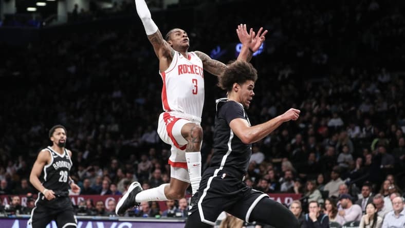 Mar 29, 2023; Brooklyn, New York, USA;  Houston Rockets guard Kevin Porter Jr. (3) goes past Brooklyn Nets forward Cameron Johnson (2) for a dunk attempt in the second quarter at Barclays Center. Mandatory Credit: Wendell Cruz-USA TODAY Sports