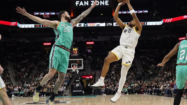 Mar 29, 2023; San Antonio, Texas, USA; Utah Jazz forward Talen Horton-Tucker (0) shoots over San Antonio Spurs forward Sandro Mamukelashvili (54) during the first half at AT&T Center. Mandatory Credit: Scott Wachter-USA TODAY Sports
