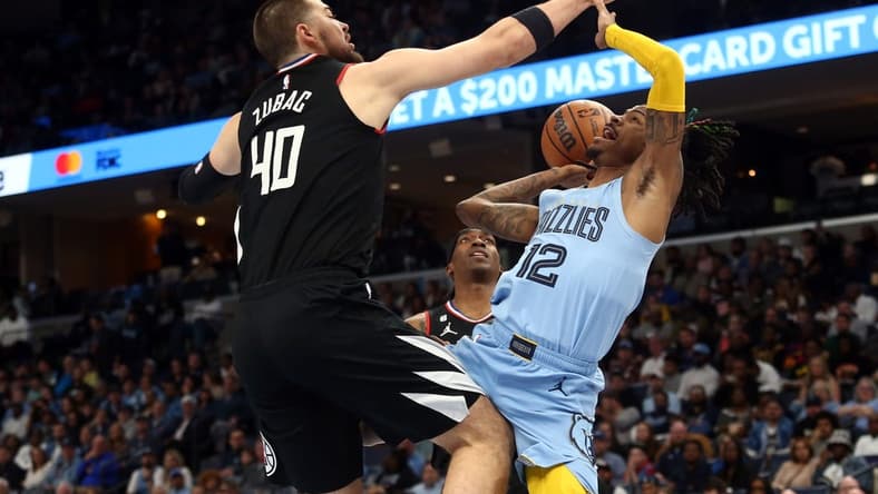 Mar 29, 2023; Memphis, Tennessee, USA; Memphis Grizzlies guard Ja Morant (12) drives to the basket as Los Angeles Clippers center Ivica Zubac (40) defends during the first half at FedExForum. Mandatory Credit: Petre Thomas-USA TODAY Sports