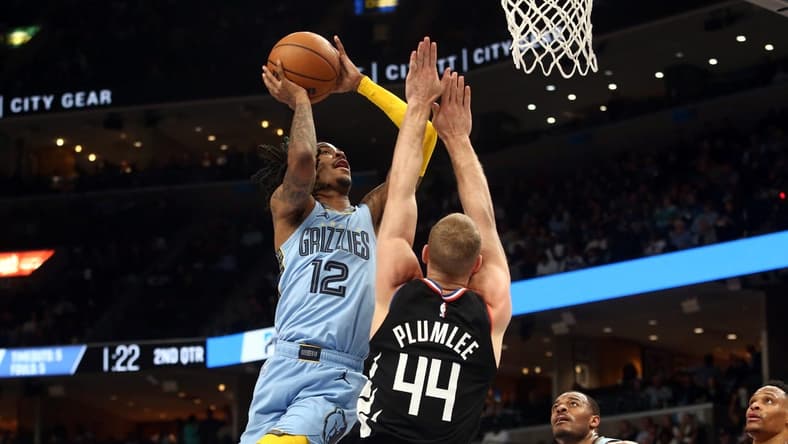 Mar 29, 2023; Memphis, Tennessee, USA; Memphis Grizzlies guard Ja Morant (12) shoots as Los Angeles Clippers center Mason Plumlee (44) defends during the first half at FedExForum. Mandatory Credit: Petre Thomas-USA TODAY Sports