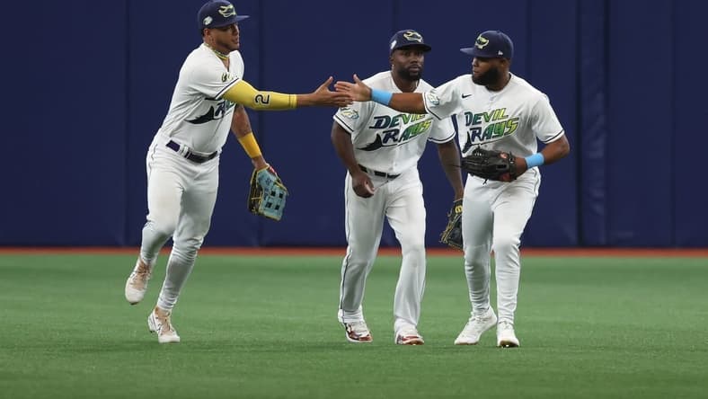 Mar 30, 2023; St. Petersburg, Florida, USA; Tampa Bay Rays center fielder Jose Siri (22), left fielder Randy Arozarena (56) and right fielder Manuel Margot (13) celebrate after they beat the Detroit Tigers at Tropicana Field. Mandatory Credit: Kim Klement-USA TODAY Sports