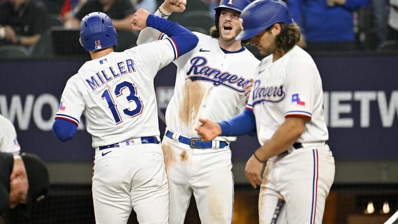Mar 30, 2023; Arlington, Texas, USA; Texas Rangers designated hitter Brad Miller (13) and catcher Jonah Heim (28) celebrate after Miller hits a two run home run against the Philadelphia Phillies during the fifth inning at Globe Life Field. Mandatory Credit: Jerome Miron-USA TODAY Sports