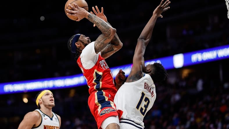 Mar 30, 2023; Denver, Colorado, USA; New Orleans Pelicans forward Brandon Ingram (14) drives to the net against Denver Nuggets center Thomas Bryant (13) in the first quarter at Ball Arena. Mandatory Credit: Isaiah J. Downing-USA TODAY Sports