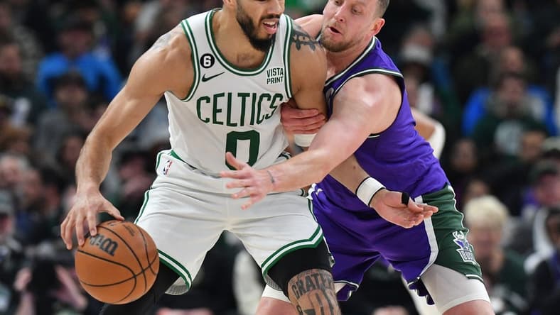 Mar 30, 2023; Milwaukee, Wisconsin, USA; Milwaukee Bucks guard Goran Dragic (7) reaches in on Milwaukee Bucks guard Boston Celtics forward Jayson Tatum (0) in the first half at Fiserv Forum. Mandatory Credit: Michael McLoone-USA TODAY Sports