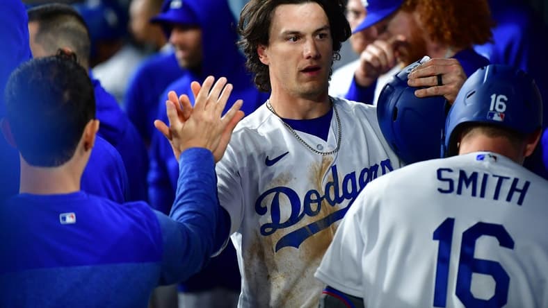Mar 30, 2023; Los Angeles, California, USA; Los Angeles Dodgers center fielder James Outman (33) is greeted after scoring a run against the Arizona Diamondbacks during the eighth inning at Dodger Stadium. Mandatory Credit: Gary A. Vasquez-USA TODAY Sports