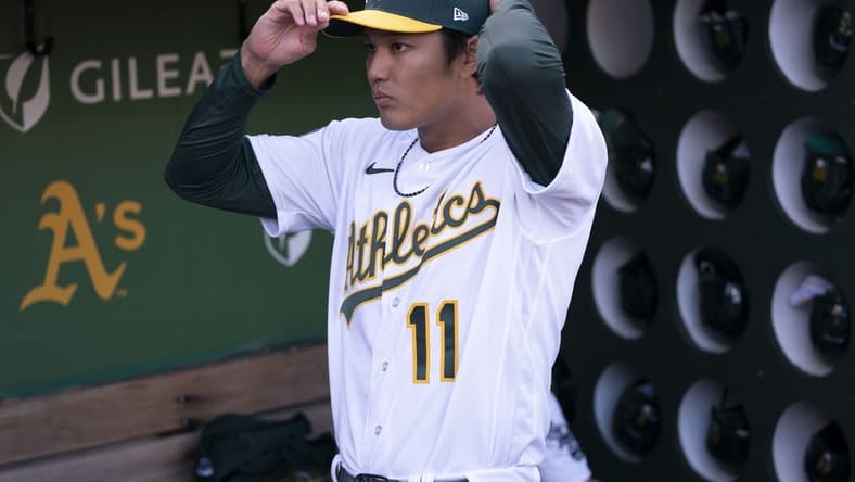 March 30, 2023; Oakland, California, USA; Oakland Athletics starting pitcher Shintaro Fujinami (11) stands in the dugout before the game against the Los Angeles Angels at RingCentral Coliseum. Mandatory Credit: Kyle Terada-USA TODAY Sports