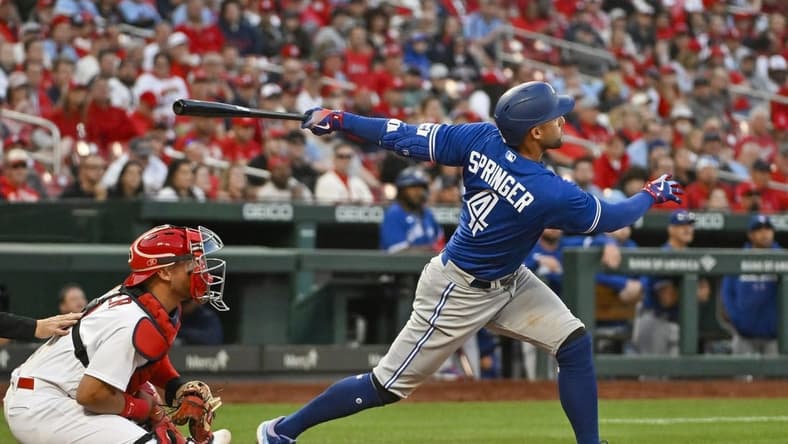 Mar 30, 2023; St. Louis, Missouri, USA;  Toronto Blue Jays right fielder George Springer (4) hits a single against the St. Louis Cardinals during the ninth inning at Busch Stadium. Mandatory Credit: Jeff Curry-USA TODAY Sports
