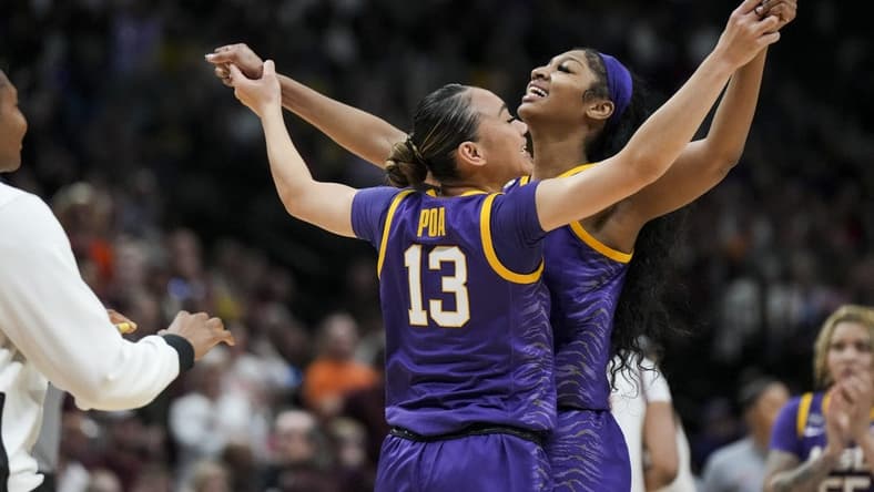 Mar 31, 2023; Dallas, TX, USA; LSU Lady Tigers guard Last-Tear Poa (13) celebrates with forward Angel Reese (10) during a stop in play against the Virginia Tech Hokies in the second half in semifinals of the women's Final Four of the 2023 NCAA Tournament at American Airlines Center. Mandatory Credit: Kirby Lee-USA TODAY Sports