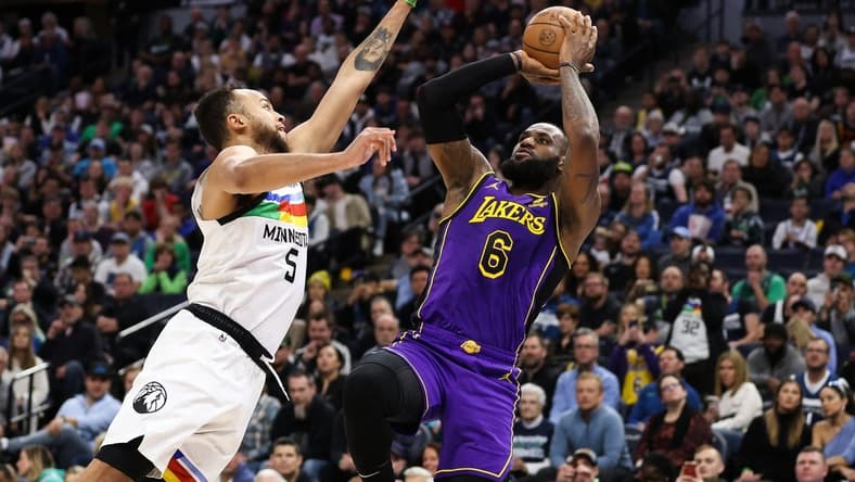 Mar 31, 2023; Minneapolis, Minnesota, USA; Los Angeles Lakers forward LeBron James (6) shoots while Minnesota Timberwolves forward Kyle Anderson (5) defends during the first quarter at Target Center. Mandatory Credit: Matt Krohn-USA TODAY Sports