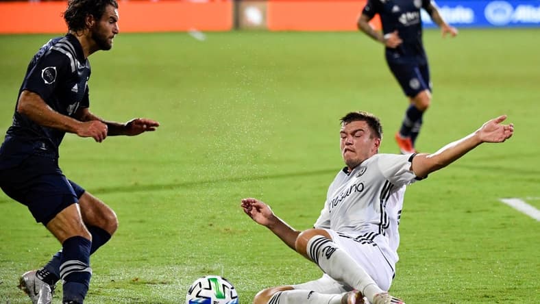 Jul 30, 2020; Orlando, FL, Florida, USA; Sporting Kansas City midfielder Graham Zusi (8) and Philadelphia Union defender Kai Wagner (27) fight for the ball during the first half at ESPN Wide World of Sports Complex. Mandatory Credit: Douglas DeFelice-USA TODAY Sports