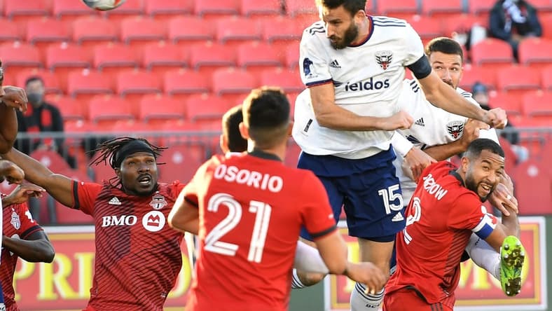 Nov 7, 2021; Toronto, Ontario, CAN; DC United defender Steven Birnbaum (15) scores on a header against Toronto FC in the first half at BMO Field. Mandatory Credit: Dan Hamilton-USA TODAY Sports