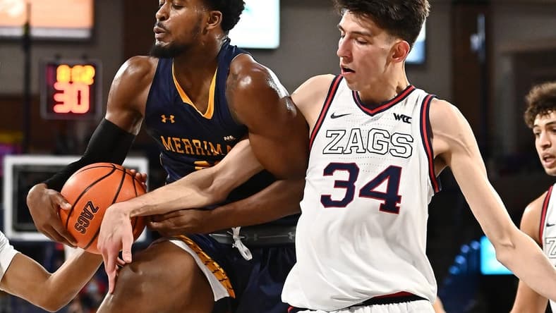 Dec 9, 2021; Spokane, Washington, USA; Merrimack Warriors forward Jordan Minor (22) rebounds the ball against Gonzaga Bulldogs center Chet Holmgren (34) in the second half at McCarthey Athletic Center. Gonzaga won 80-55. Mandatory Credit: James Snook-USA TODAY Sports