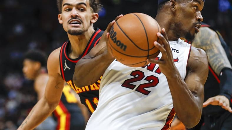 Jan 14, 2022; Miami, Florida, USA; Miami Heat forward Jimmy Butler (22) protects the ball from Atlanta Hawks guard Trae Young (11) during the second quarter of the game at FTX Arena. Mandatory Credit: Sam Navarro-USA TODAY Sports