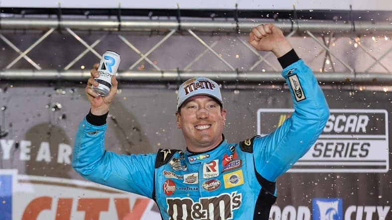 Apr 17, 2022; Bristol, Tennessee, USA; NASCAR Cup Series driver Kyle Busch (18) reacts after winning the Bristol Motor Speedway Dirt Course. Mandatory Credit: Randy Sartin-USA TODAY Sports