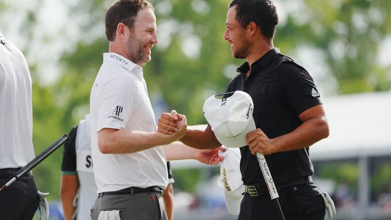 Apr 24, 2022; Avondale, Louisiana, USA; Xander Schauffele (right) embraces Patrick Cantlay (left) on the 18th green during the final round of the Zurich Classic of New Orleans golf tournament. Mandatory Credit: Andrew Wevers-USA TODAY Sports