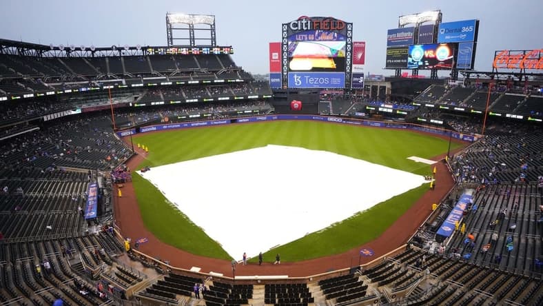 May 14, 2022; New York City, New York, USA; A tarp covers the infield at Citi Field  due to rain before the delayed start of a game between the Seattle Mariners and New York Mets. Mandatory Credit: Gregory Fisher-USA TODAY Sports