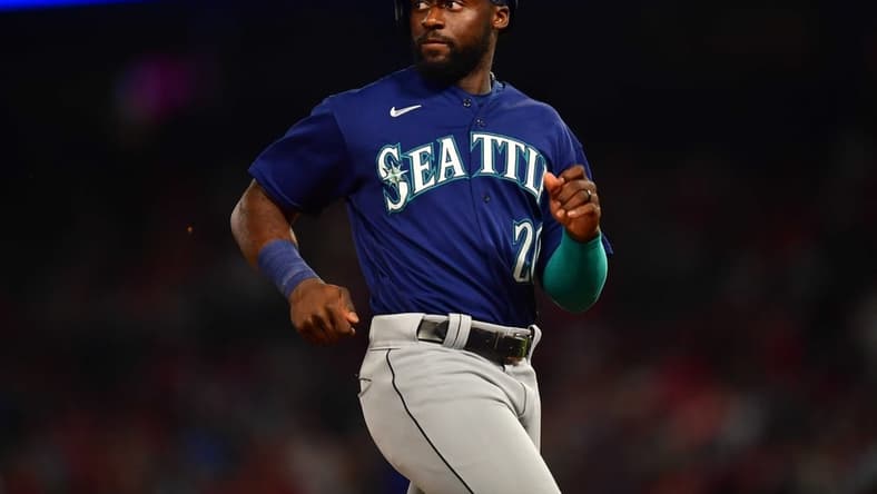 June 25, 2022; Anaheim, California, USA; Seattle Mariners pinch runner Taylor Trammell (20) reaches third against the Los Angeles Angels during the seventh inning at Angel Stadium. Mandatory Credit: Gary A. Vasquez-USA TODAY Sports