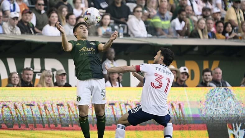 Jul 17, 2022; Portland, Oregon, USA; Vancouver Whitecaps midfielder Russell Teibert (31) defends Portland Timbers defender Claudio Bravo (5) during the first half at Providence Park. The game ended tied 1-1. Mandatory Credit: Troy Wayrynen-USA TODAY Sports