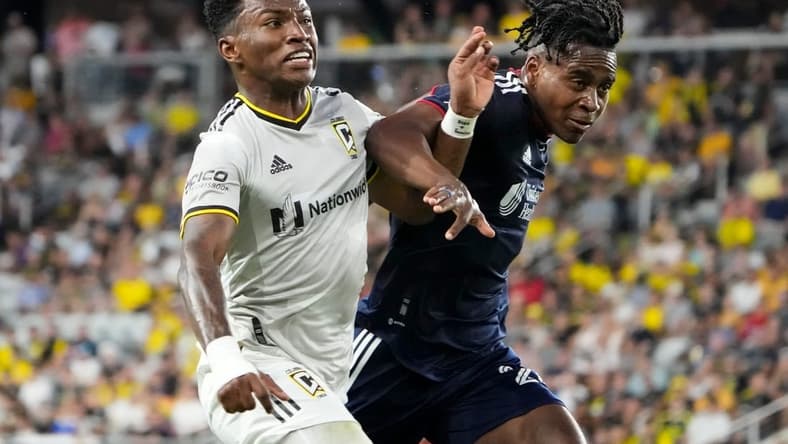 Jul 23, 2022; Columbus, Ohio, USA; Columbus Crew midfielder Luis Diaz (12) fights with New England Revolution forward DeJuan Jones (24) to get to a ball during the second half of the MLS soccer game at Lower.com Field. Mandatory Credit: Adam Cairns-The Columbus Dispatch

Mls New England Revolution At Columbus Crew