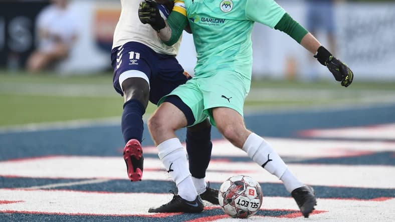 One Knoxville SC's Stephen Afrifa (11) tries to block a kick from West Virginia United goalkeeper Max Collingwood (1) during the regional final soccer match of the USL League Two playoffs at West High School in Knoxville, Tenn. on Sunday, July 24, 2022.

Kns One Knox Regional Championship