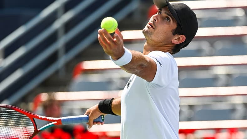 Aug 7, 2022; Montreal, Quebec, Canada; Marcos Giron (USA) serves the ball against Alexei Popyrin (AUS) (not pictured) in second round qualifying play at IGA Stadium. Mandatory Credit: David Kirouac-USA TODAY Sports