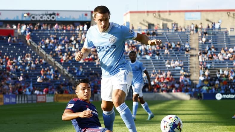 Aug 21, 2022; Chicago, Illinois, USA; Chicago Fire midfielder Jairo Torres (7) kicks the ball against New York City defender Malte Amundsen (12) during the first half at Bridgeview Stadium. Mandatory Credit: Mike Dinovo-USA TODAY Sports