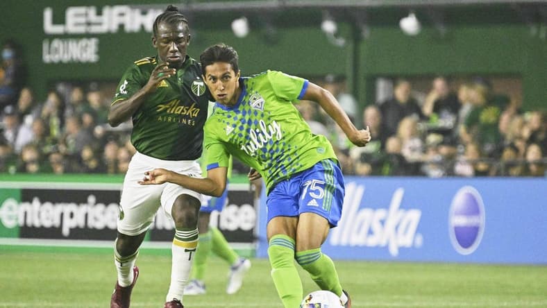 Aug 26, 2022; Portland, Oregon, USA; Seattle Sounders midfielder Danny Leyva (75) passes the ball during the second half against Portland Timbers midfielder Diego Chara (21) at Providence Park.The Timbers won 2-1. Mandatory Credit: Troy Wayrynen-USA TODAY Sports