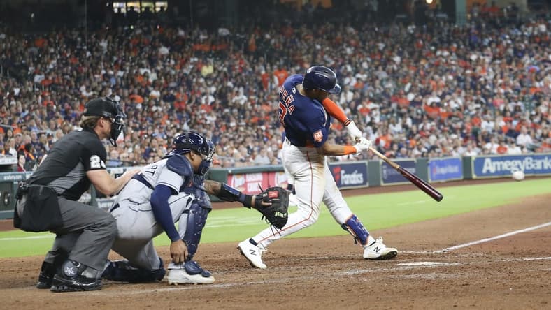 Oct 2, 2022; Houston, Texas, USA;  Houston Astros shortstop Jeremy Pena (3) hits a RBI single against the Tampa Bay Rays in the seventh inning at Minute Maid Park. Mandatory Credit: Thomas Shea-USA TODAY Sports