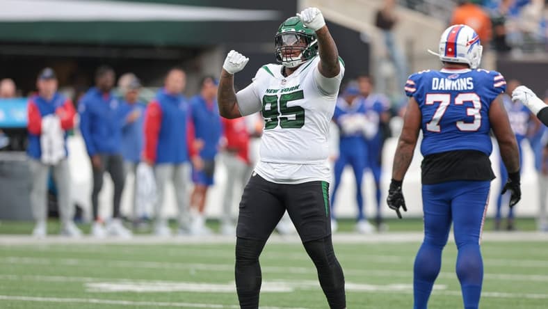 Nov 6, 2022; East Rutherford, New Jersey, USA; New York Jets defensive tackle Quinnen Williams (95) celebrates a defensive stop being Buffalo Bills offensive tackle Dion Dawkins (73) during the second half at MetLife Stadium. Mandatory Credit: Vincent Carchietta-USA TODAY Sports