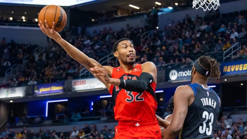 Nov 12, 2022; Indianapolis, Indiana, USA; Toronto Raptors forward Otto Porter Jr. (32) shoots the ball while Indiana Pacers center Myles Turner (33) defends in the first quarter at Gainbridge Fieldhouse. Mandatory Credit: Trevor Ruszkowski-USA TODAY Sports
