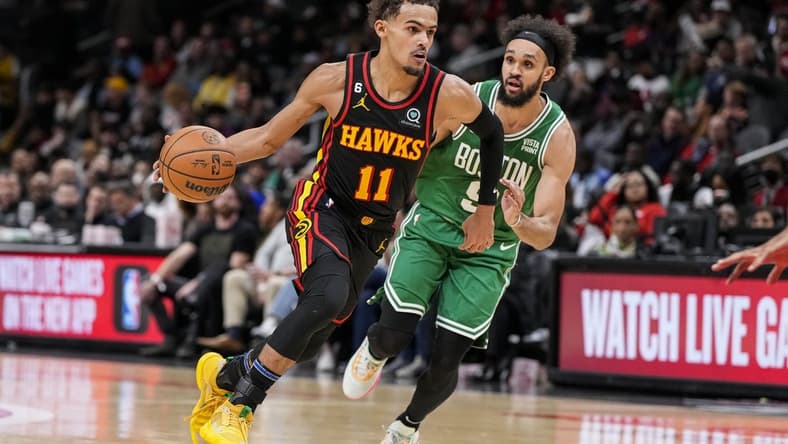 Nov 16, 2022; Atlanta, Georgia, USA; Atlanta Hawks guard Trae Young (11) dribbles past Boston Celtics guard Derrick White (9) during the second half at State Farm Arena. Mandatory Credit: Dale Zanine-USA TODAY Sports