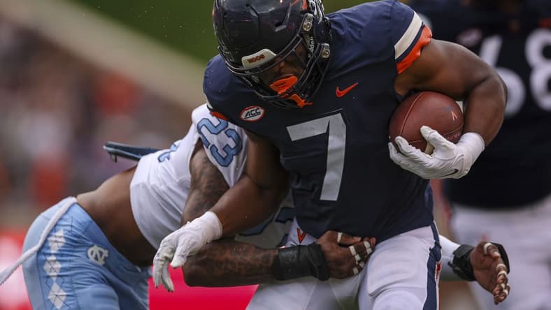 Nov 5, 2022; Charlottesville, Virginia, USA; Virginia Cavaliers running back Mike Hollins (7) carries the ball against the North Carolina Tar Heels during the first half at Scott Stadium. Mandatory Credit: Scott Taetsch-USA TODAY Sports