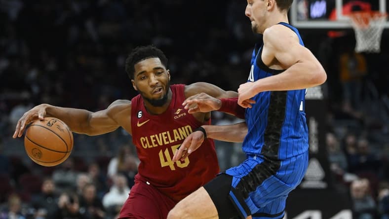 Dec 2, 2022; Cleveland, Ohio, USA; Orlando Magic forward Franz Wagner (22) defends Cleveland Cavaliers guard Donovan Mitchell (45) during the second half at Rocket Mortgage FieldHouse. Mandatory Credit: Ken Blaze-USA TODAY Sports
