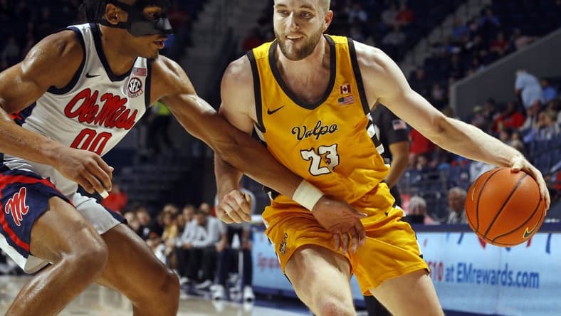 Dec 10, 2022; Oxford, Mississippi, USA; Valparaiso Beacons forward Ben Krikke (23) drives to the basket as Mississippi Rebels forward Jayveous McKinnis (0) defends during the first half at The Sandy and John Black Pavilion at Ole Miss. Mandatory Credit: Petre Thomas-USA TODAY Sports
