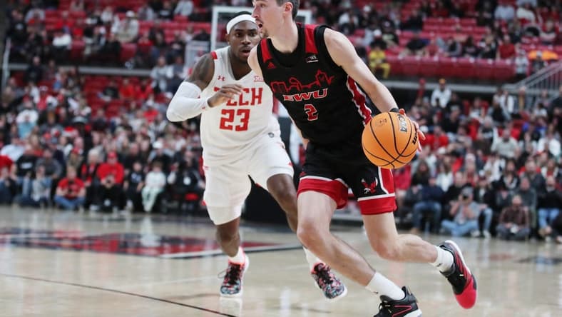 Dec 13, 2022; Lubbock, Texas, USA; Eastern Washington Eagles forward Steele Venters (2) drives to the lane against Texas Tech Red Raiders guard De Vion Harmon (23) in the second half at United Supermarkets Arena. Mandatory Credit: Michael C. Johnson-USA TODAY Sports
