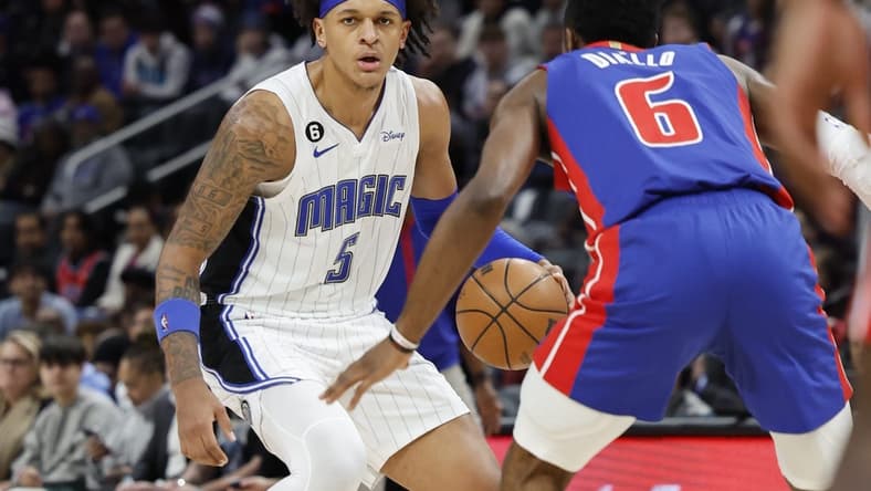 Dec 28, 2022; Detroit, Michigan, USA;  Orlando Magic forward Paolo Banchero (5) dribbles defended by Detroit Pistons guard Hamidou Diallo (6) in the first half at Little Caesars Arena. Mandatory Credit: Rick Osentoski-USA TODAY Sports