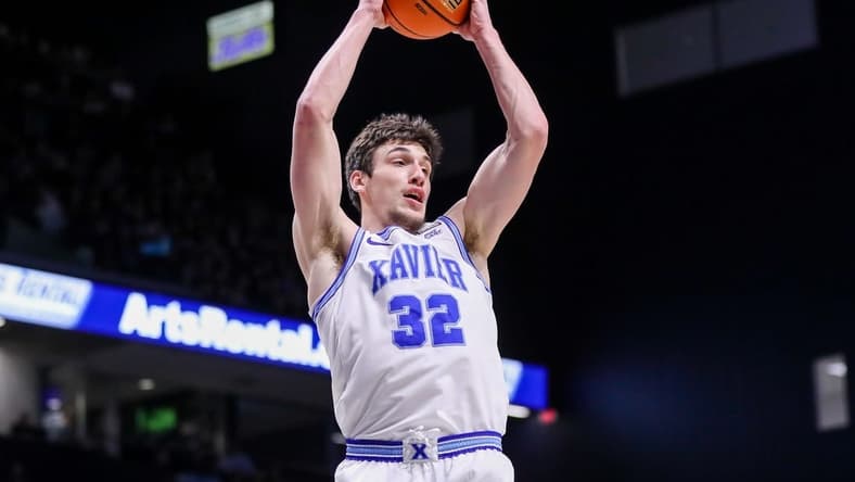 Jan 21, 2023; Cincinnati, Ohio, USA; Xavier Musketeers forward Zach Freemantle (32) grabs the rebound against the Georgetown Hoyas in the first half at Cintas Center. Mandatory Credit: Katie Stratman-USA TODAY Sports