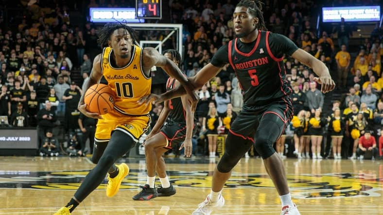 Jan 25, 2023; Wichita, Kansas, USA; Wichita State Shockers guard Jaykwon Walton (10) drives around Houston Cougars forward Ja'Vier Francis (5) during the second half at Charles Koch Arena. Mandatory Credit: William Purnell-USA TODAY Sports