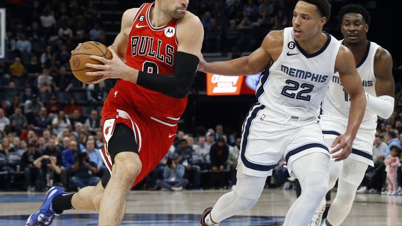 Feb 7, 2023; Memphis, Tennessee, USA; Chicago Bulls center Nikola Vucevic (9) drives to the basket as Memphis Grizzlies guard Desmond Bane (22) defends during the second half at FedExForum. Mandatory Credit: Petre Thomas-USA TODAY Sports