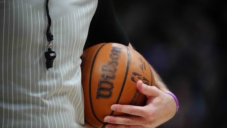 Feb 15, 2023; Denver, Colorado, USA; A detailed view of the game basketball held by referee Brett Nansel (44) during the second quarter between the Dallas Mavericks against the Denver Nuggets at Ball Arena. Mandatory Credit: Ron Chenoy-USA TODAY Sports