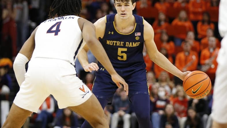 Feb 18, 2023; Charlottesville, Virginia, USA; Notre Dame Fighting Irish guard Cormac Ryan (5) controls the ball as Virginia Cavaliers guard Armaan Franklin (4) defends during the first half at John Paul Jones Arena. Mandatory Credit: Amber Searls-USA TODAY Sports