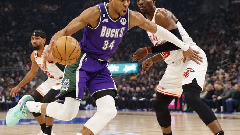 Feb 24, 2023; Milwaukee, Wisconsin, USA; Milwaukee Bucks forward Giannis Antetokounmpo (34) drives for the basket against Miami Heat center Bam Adebayo (13) during the first quarter at Fiserv Forum. Mandatory Credit: Jeff Hanisch-USA TODAY Sports