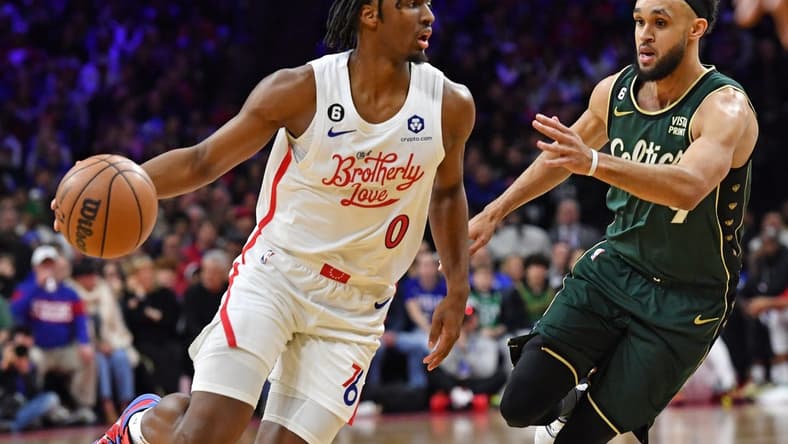 Feb 25, 2023; Philadelphia, Pennsylvania, USA; Philadelphia 76ers guard Tyrese Maxey (0) drives to the basket against Boston Celtics guard Jaylen Brown (7) at Wells Fargo Center. Mandatory Credit: Eric Hartline-USA TODAY Sports