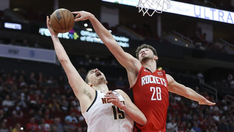 Feb 28, 2023; Houston, Texas, USA; Denver Nuggets center Nikola Jokic (15) attempts to score as Houston Rockets center Alperen Sengun (28) defends during the third quarter at Toyota Center. Mandatory Credit: Troy Taormina-USA TODAY Sports
