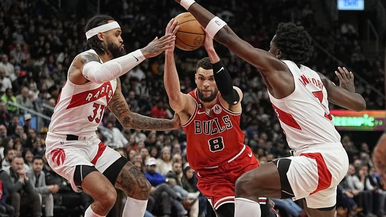 Feb 28, 2023; Toronto, Ontario, CAN; Chicago Bulls guard Zach LaVine (8) tries to get past Toronto Raptors guard Gary Trent Jr. (33) and forward O.G. Anunoby (3) during the second half at Scotiabank Arena. Mandatory Credit: John E. Sokolowski-USA TODAY Sports