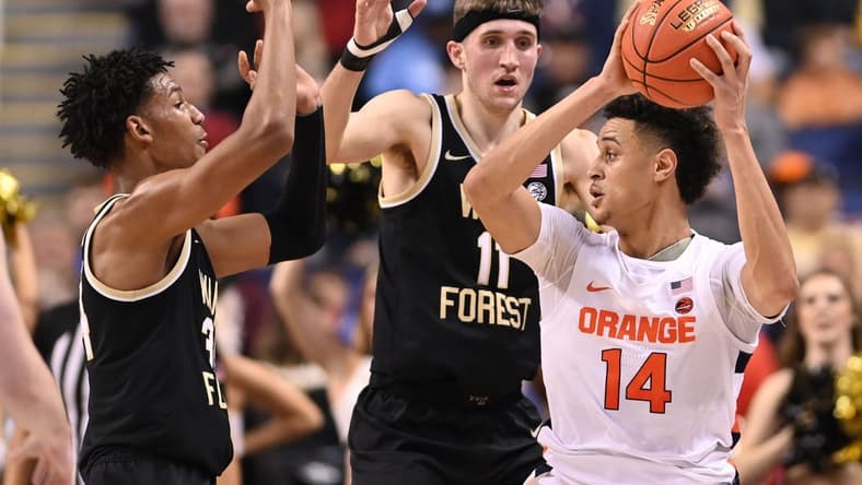 Mar 8, 2023; Greensboro, NC, USA; Syracuse Orange center Jesse Edwards (14) with the ball as Wake Forest Demon Deacons forward Bobi Klintman (34) and forward Andrew Carr (11) defend in the first half of the second round at Greensboro Coliseum. Mandatory Credit: Bob Donnan-USA TODAY Sports
