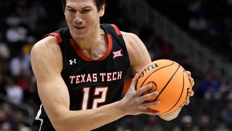 Texas Tech's forward Daniel Batcho (12) rebounds the ball against West Virginia in the first round of the Big 12 basketball tournament, Wednesday, March 8, 2023, at T-Mobile Center in Kansas City.