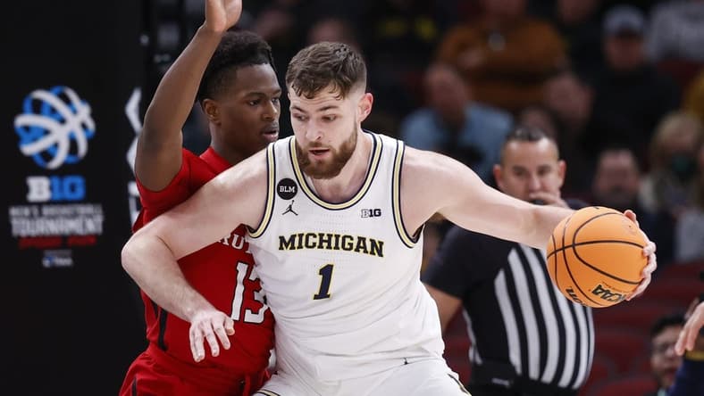 Mar 9, 2023; Chicago, IL, USA; Michigan Wolverines center Hunter Dickinson (1) is defended by Rutgers Scarlet Knights forward Antwone Woolfolk (13) during the first half at United Center. Mandatory Credit: Kamil Krzaczynski-USA TODAY Sports