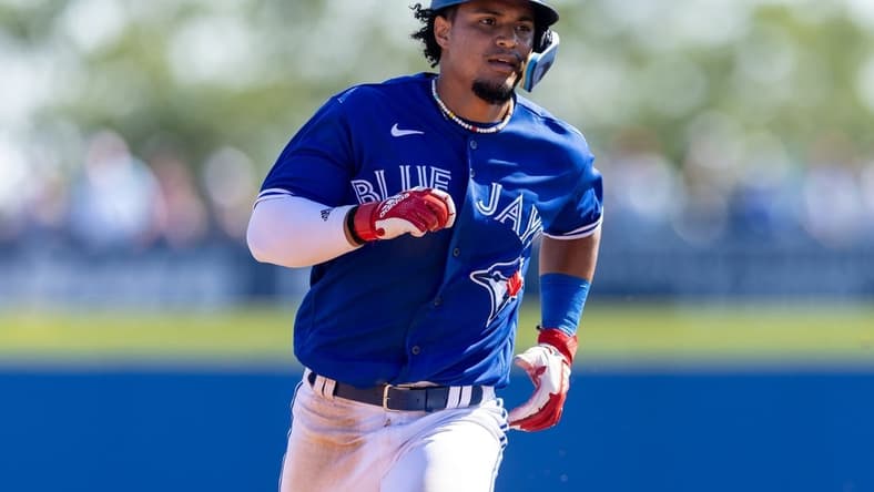 Mar 11, 2023; Dunedin, Florida, USA;  Toronto Blue Jays second baseman Santiago Espinal (5) triples against the Baltimore Orioles in the sixth inning during spring training at TD Ballpark. Mandatory Credit: Nathan Ray Seebeck-USA TODAY Sports